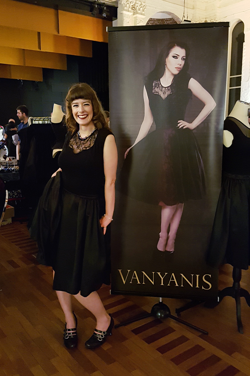 Our assistant Erika standing next to a banner of Morgana © Vanyanís